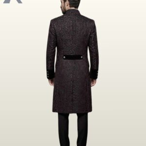 Full rear model view of a men's dark plum purple damask gothic frock coat highlighting a black velvet back waist belt and center seam split.