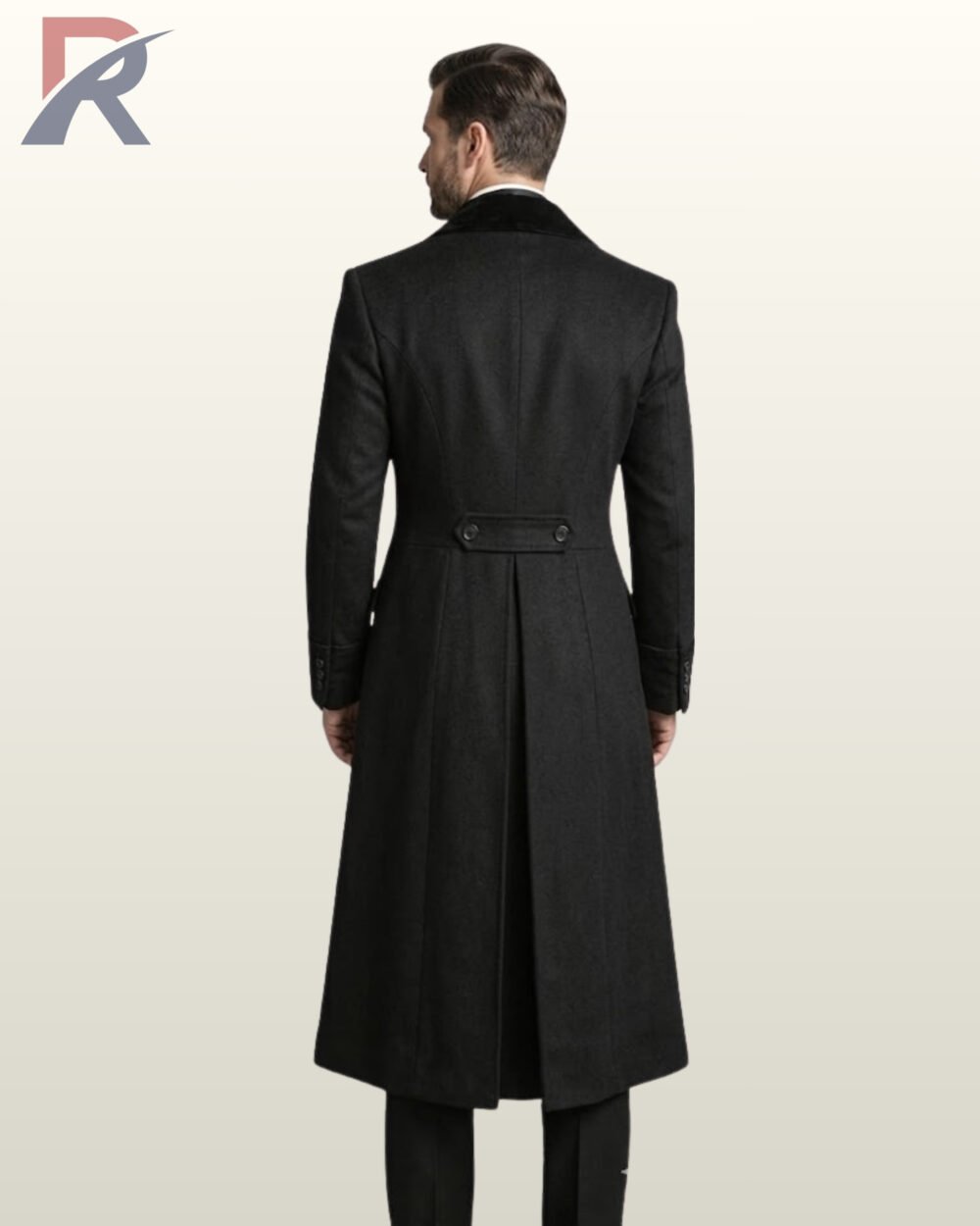 Full rear model view of a men's black wool Victorian frock coat showing a velvet upper collar, buttoned back half-belt waist, structured princess seams, and a long pleated split vent.