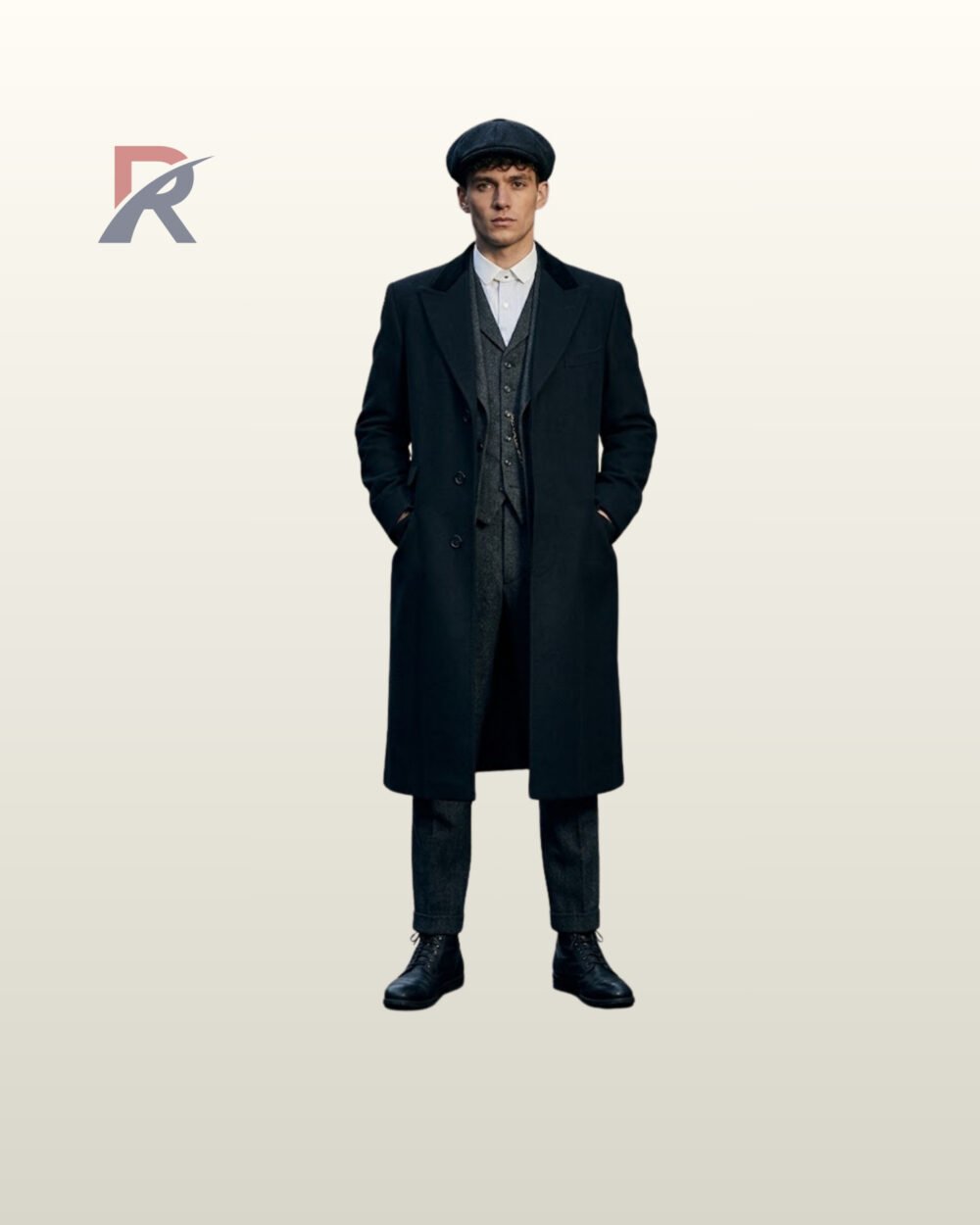 Men's vintage Peaky Blinders coat styled with dark velvet notch lapels, hands in coat pockets, collared shirt, and black lace-up boots.