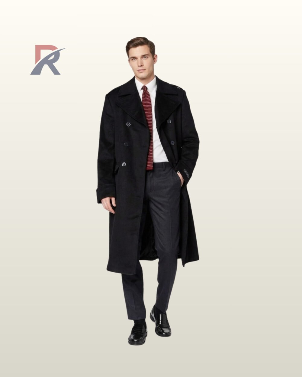 Men's formal black winter trench coat styled over charcoal dress trousers, white collared shirt, red polka dot tie, and polished leather loafers.