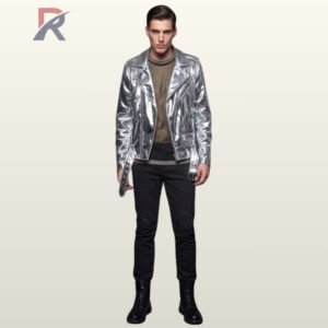 Full front view of a male model wearing an asymmetrical metallic silver patent leather motorcycle jacket over a mesh top with black slim-fit trousers.