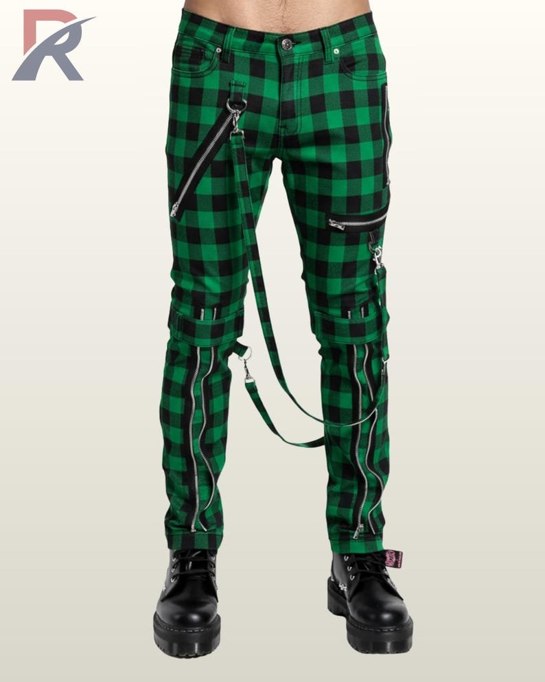 Full front view of a male model wearing emerald green and black buffalo plaid punk bondage pants with metallic hardware and straps.