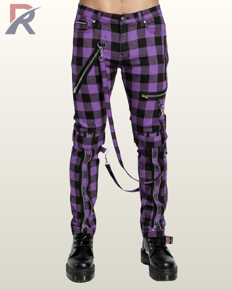 Full front view of a male model wearing vibrant purple and black buffalo plaid punk bondage pants with silver zippers and straps.