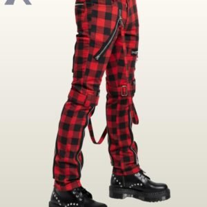 Three-quarter side profile view of a model wearing red buffalo plaid punk bondage pants displaying thigh buckled straps and silver zipper pockets.