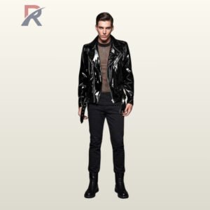 Full front view of a male model wearing an asymmetrical glossy black patent leather biker jacket styled over a see-through mesh shirt.