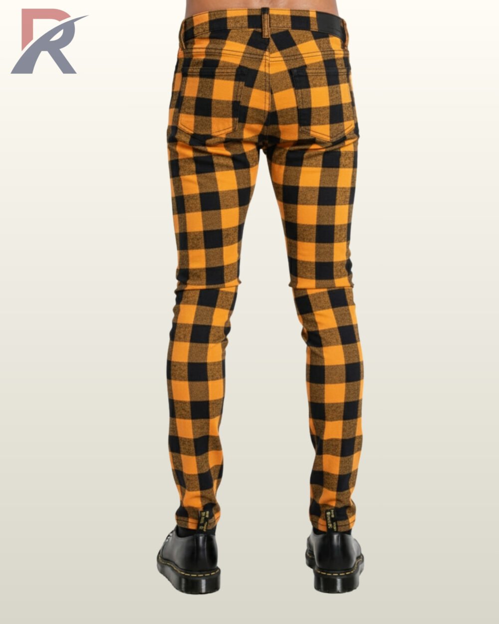 High-contrast orange and black tartan skinny jeans ideal for gothic and rock styles.
