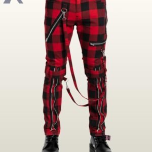Full front view of a male model wearing crimson red and black buffalo plaid punk bondage pants with silver metal zippers, thigh buckles, and hanging D-ring bondage straps.