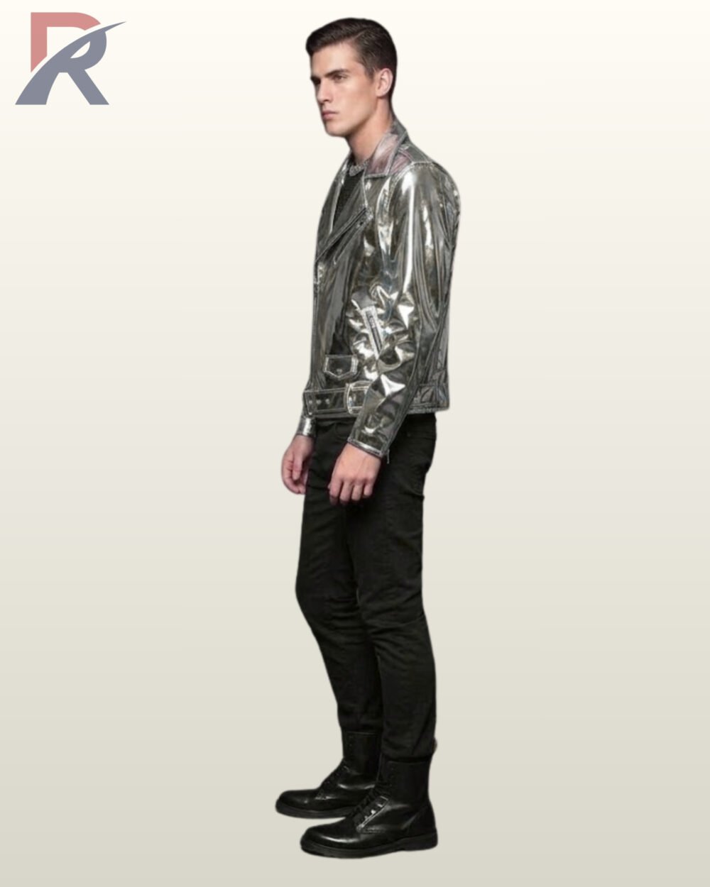 Side profile view of a model wearing a metallic silver patent leather biker jacket detailing sleeve zips, lapel snaps, and waist belt hardware.