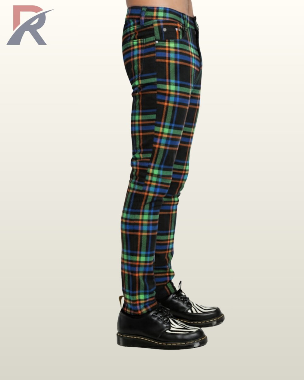 Side profile view of a model wearing men's black skinny punk trousers with vibrant neon green, orange, and blue tartan grid lines.