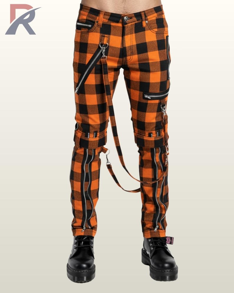 Men's pumpkin orange checkered gothic bondage trousers featuring front zipper accents, thigh buckled straps, and platform boots.