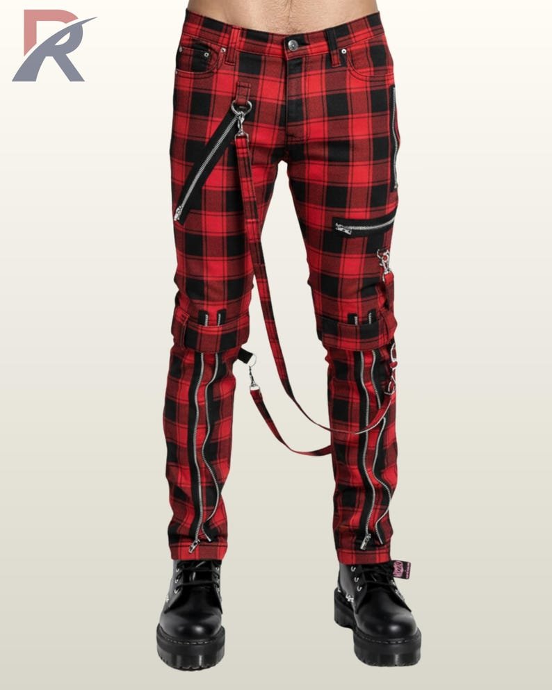Full front view of a male model wearing red and black buffalo plaid punk bondage pants with silver zippers, thigh straps, and hanging D-ring bondage straps.