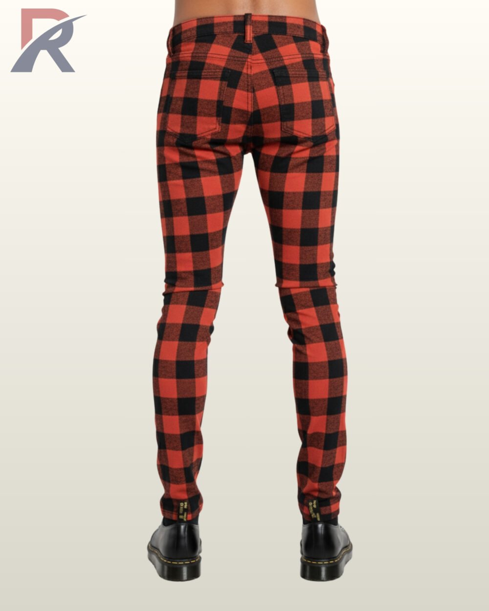 Full rear view of a male model wearing men's red and black buffalo plaid skinny punk pants showing fitted rear seat paneling and back pockets.