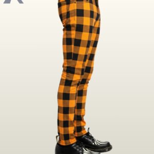 Slim-fit orange buffalo plaid men's trousers worn with black and white creepers.