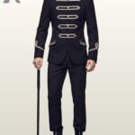 Full front view of a male model wearing a black gothic hussar military suit with horizontal silver braided frogging bars, silver dome buttons, and embroidered flap pockets.