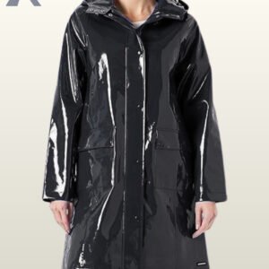 A woman modeling a sleek, high-gloss black vinyl raincoat with a hood.