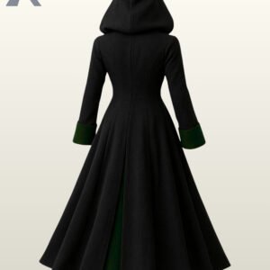 Full rear view of a long black hooded gothic overcoat showing emerald green wool cuff trim and fitted waist seam construction.