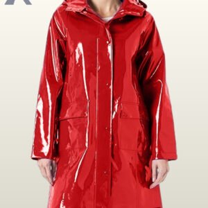 A woman wearing a vibrant, high-gloss red vinyl raincoat featuring an attached hood.