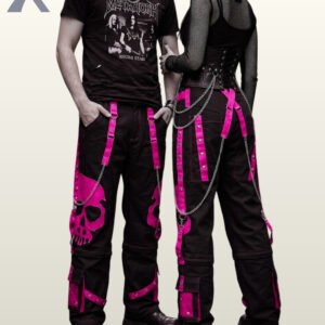 Gothic couple posing in wide-leg black cargo pants featuring high-contrast pink skull artwork.