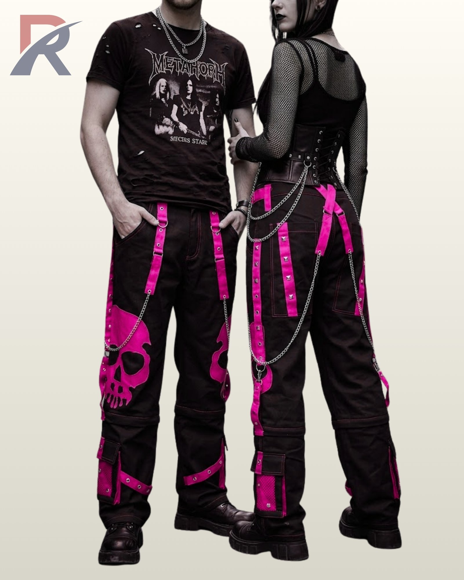 Gothic couple posing in wide-leg black cargo pants featuring high-contrast pink skull artwork.