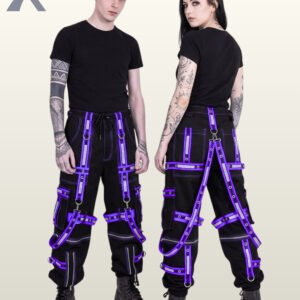 Couple in black gothic reflective cargo trousers trimmed with purple eyelet straps, suspender harnesses, and cargo pockets.