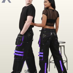 Rear angle of a man and woman modeling cyber goth wide-leg trousers featuring purple trim, grommets, and silver chains.