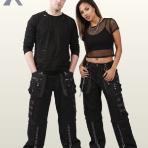 Front perspective of a man and woman modeling all-black industrial goth trousers detailed with studded straps and metal hardware.