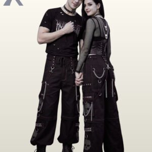 Couple wearing black gothic cargo pants styled with subtle grey stitching, dark grey skull graphics, and metal chains.
