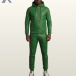 A man standing in an emerald green leather hooded tracksuit with bold white stripes.