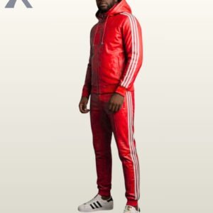 A full-length profile shot of a bright red leather track hoodie and matching pants.