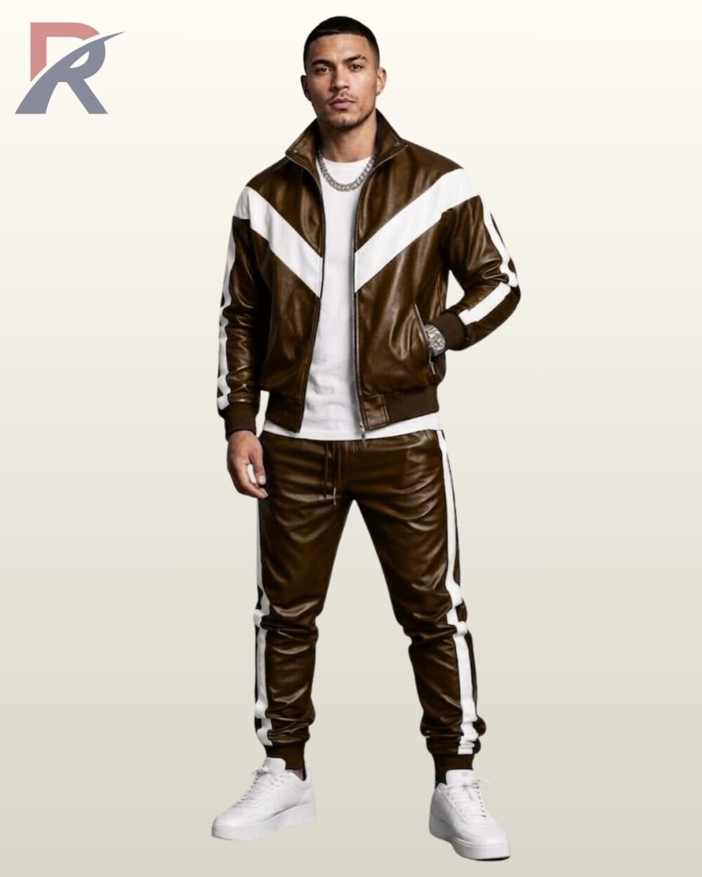 Men's brown leather zip jacket and cuffed joggers matching set styled with white sneakers.