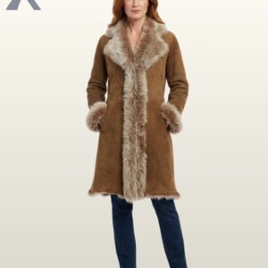 A model showcasing a luxury mid-length tan sheepskin winter coat with dramatic fur lapels and cuffs.