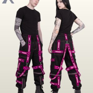Couple wearing black gothic cargo pants accented with hot pink reflective straps, grommet details, and suspender straps.