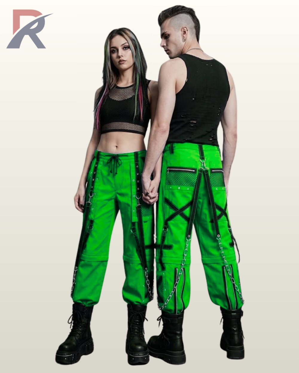 Man and woman posing in neon green alternative streetwear trousers featuring black eyelet straps and hanging silver chains.