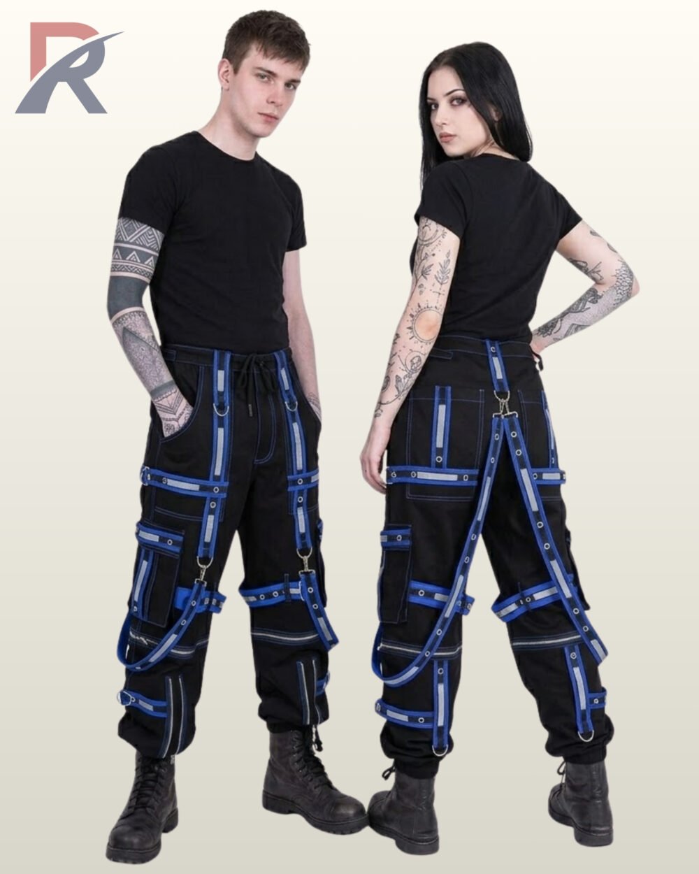 Man and woman modeling dark cyber goth reflective jogger trousers trimmed with blue bondage straps and silver hardware.