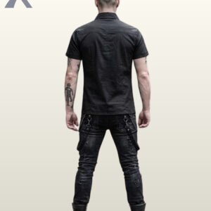 Full rear view of a tattooed male model wearing a black short-sleeve gothic button-down shirt paired with distressed black jeans and combat boots.