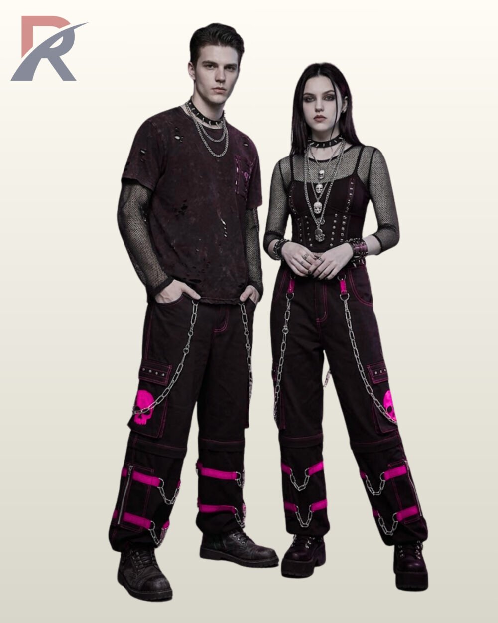 Couples catalog display of loose black cyberpunk cargo pants featuring neon pink buckle leg bands, skull pocket graphics, and hanging silver side chains.
