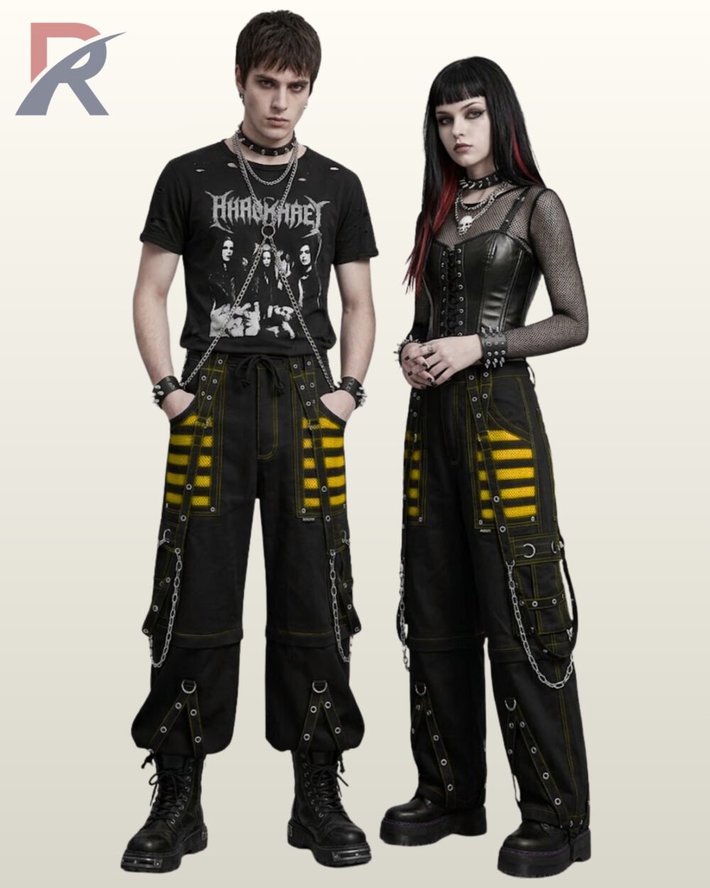 Couple wearing loose-fit black gothic trousers with bright yellow mesh panel accents and silver metal chains.