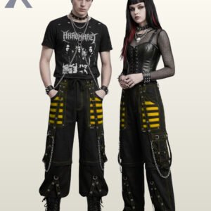 Couple wearing loose-fit black gothic trousers with bright yellow mesh panel accents and silver metal chains.
