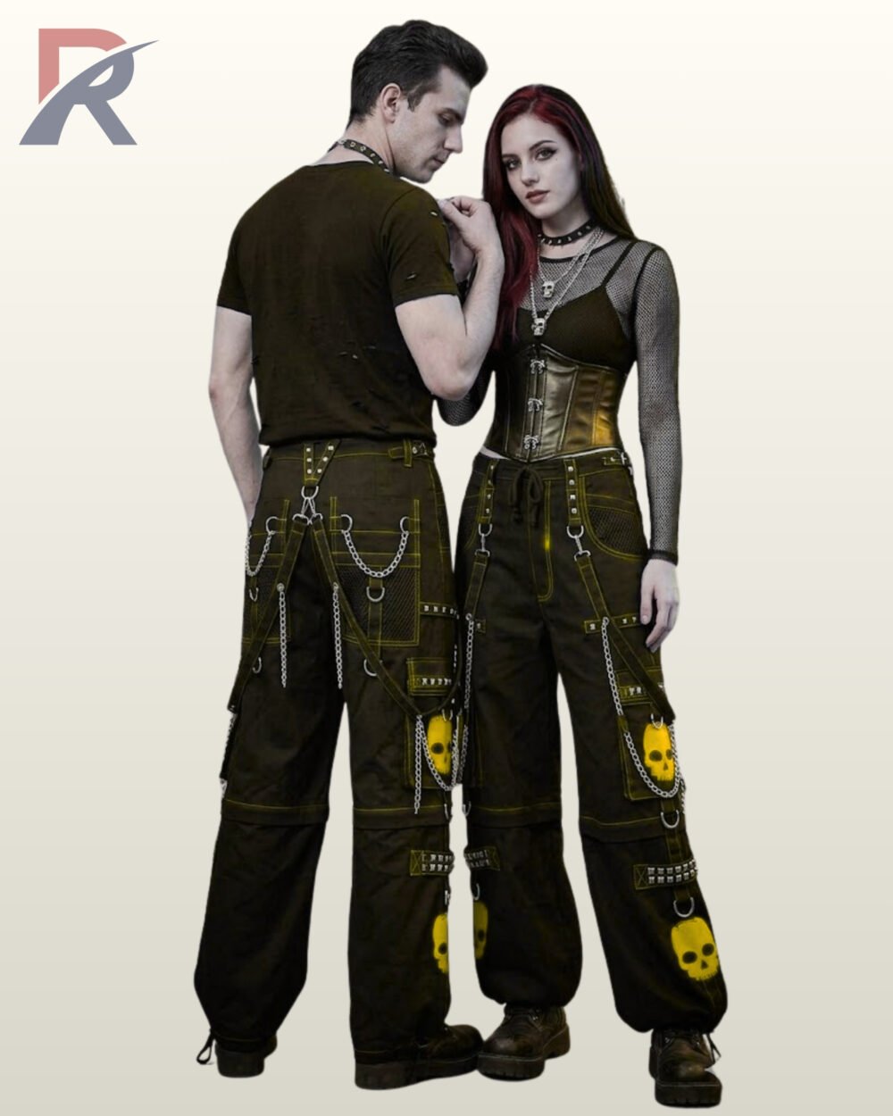 Couple wearing wide-leg black gothic pants trimmed with yellow stitching, skull prints, and metal chains.