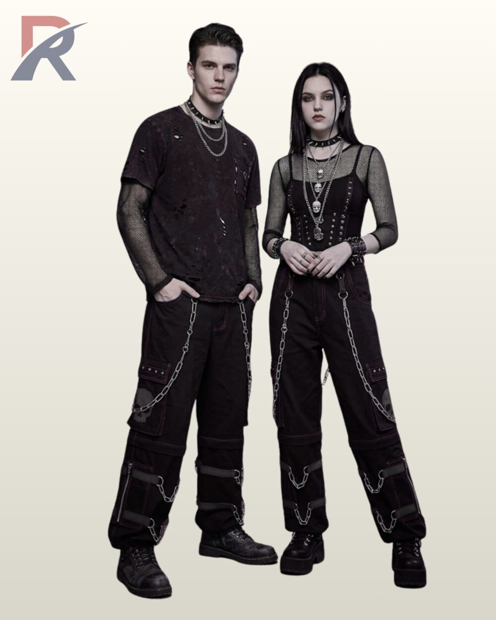 Full model view of a male and female wearing monochromatic black gothic skull cargo pants with dark grey contrast stitching, black skull patches, and metal chains.