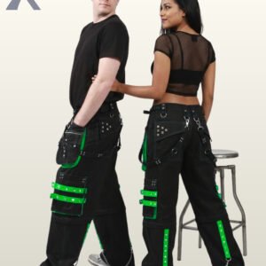 Side and rear view of a couple wearing black gothic wide-leg cargo trousers trimmed with bright neon green studded straps and metal chains.