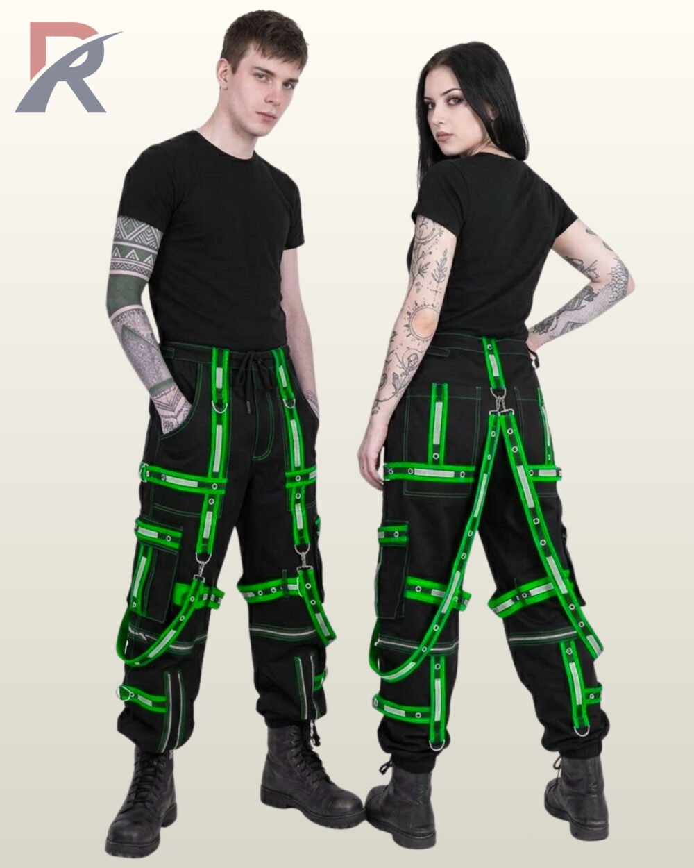 Couple wearing black gothic cargo joggers with bright neon green reflective straps, eyelets, and harness suspenders.