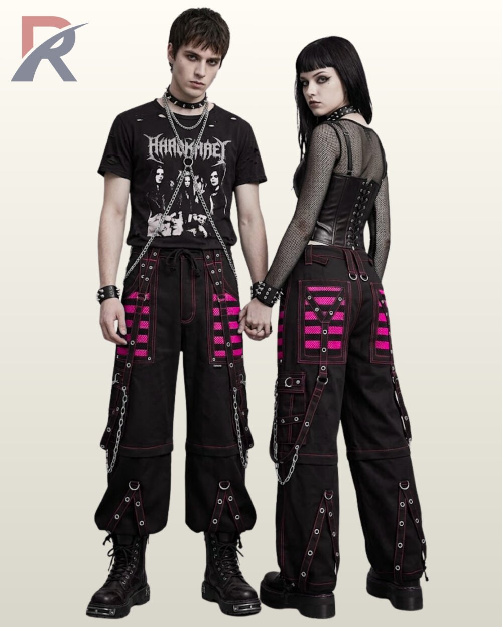 Couple posing in wide-leg alternative streetwear pants styled with hot pink mesh accents and grommeted straps.