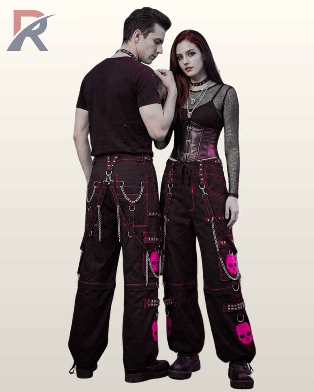 Couple posing in dark cyber goth wide-leg pants featuring bold hot pink skull graphics and bondage straps.
