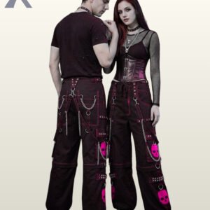 Couple posing in dark cyber goth wide-leg pants featuring bold hot pink skull graphics and bondage straps.