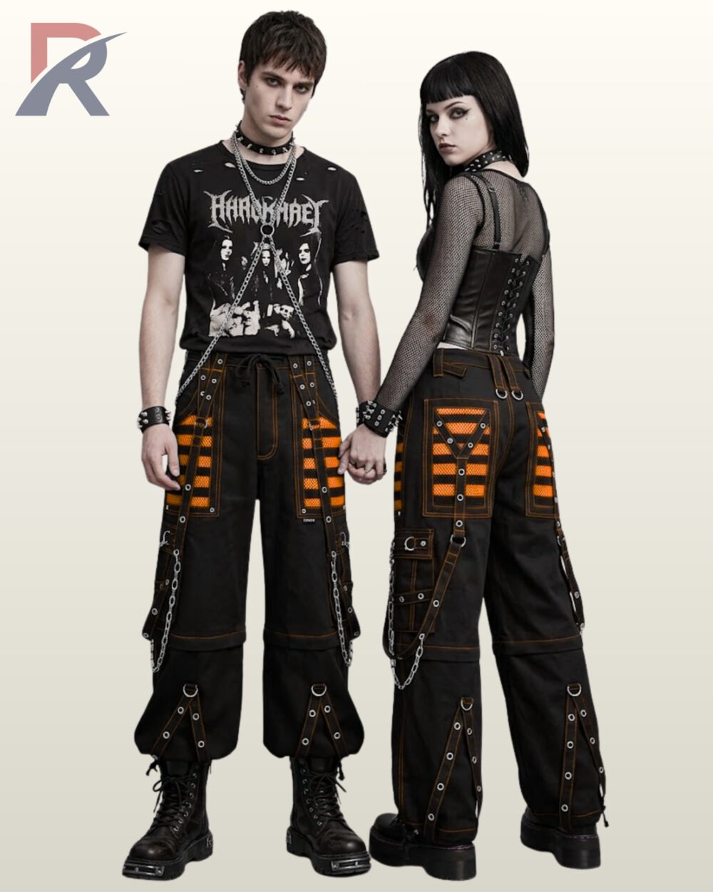 Black baggy gothic cargo pants trimmed with bright orange mesh panels, contrast stitching, and metal eyelet straps.