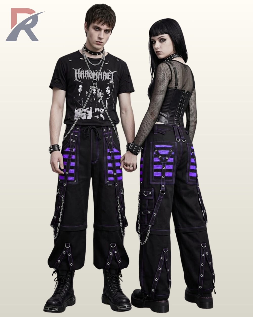 Man and woman holding hands modeling cyber goth wide-leg trousers accented with bright purple mesh and metal hardware.