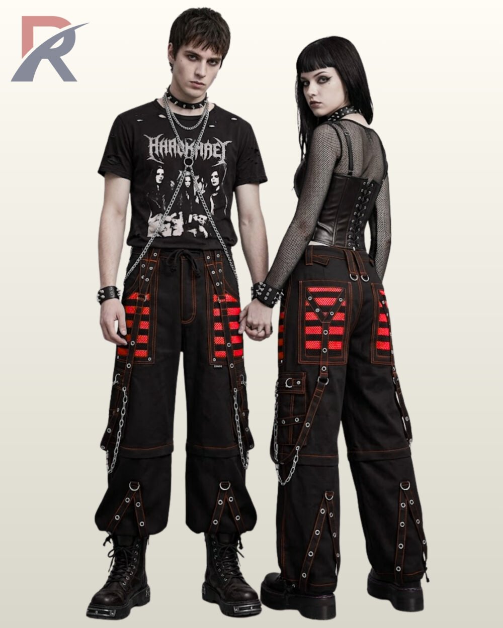 Man and woman modeling dark industrial goth trousers accented with bold red mesh panels and silver-tone chains.