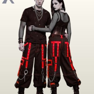 Alternative fashion couple wearing baggy black punk trousers styled with red trim and metallic accents.
