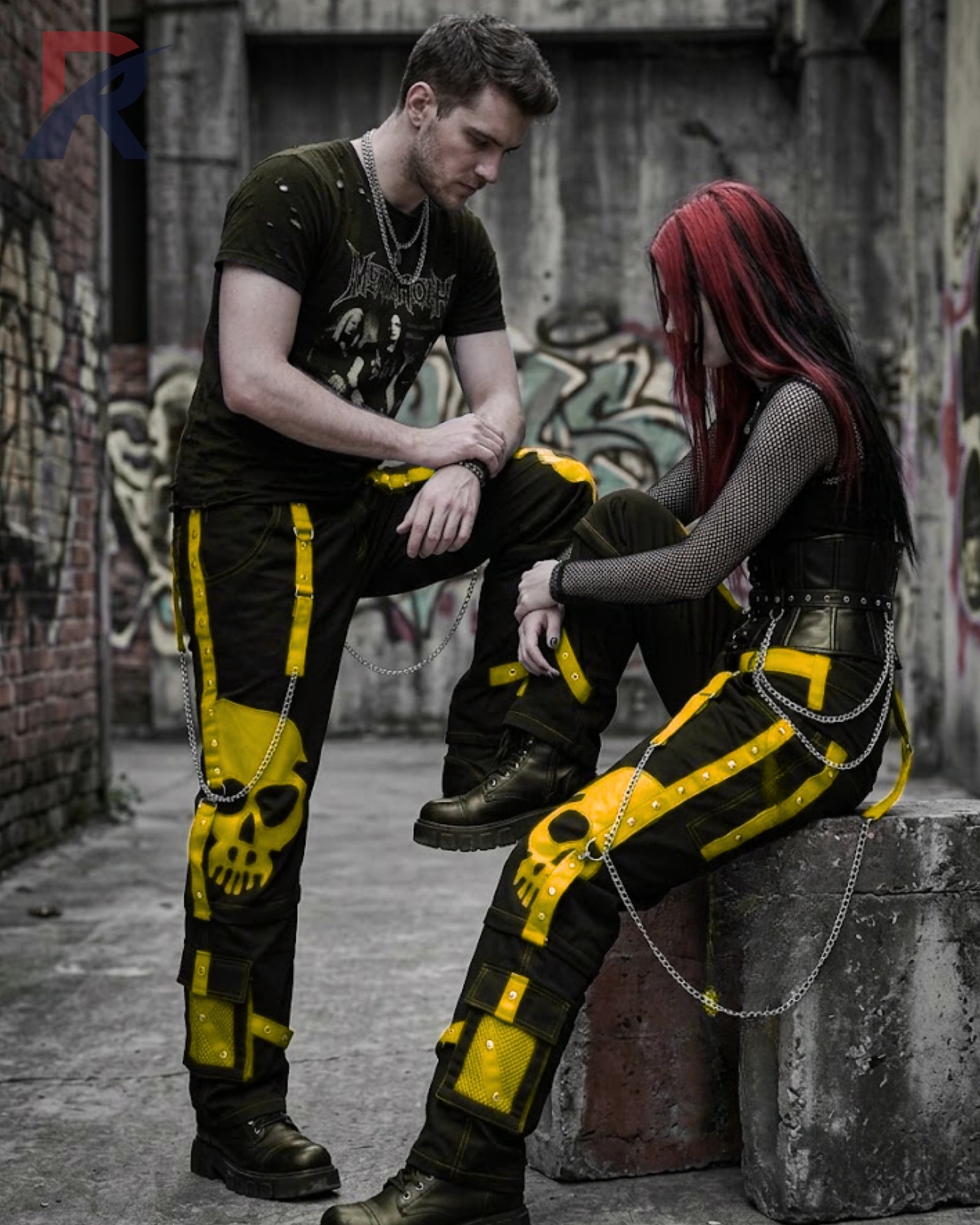 Black wide-leg gothic cargo pants featuring a bright yellow skull print and metallic chains.